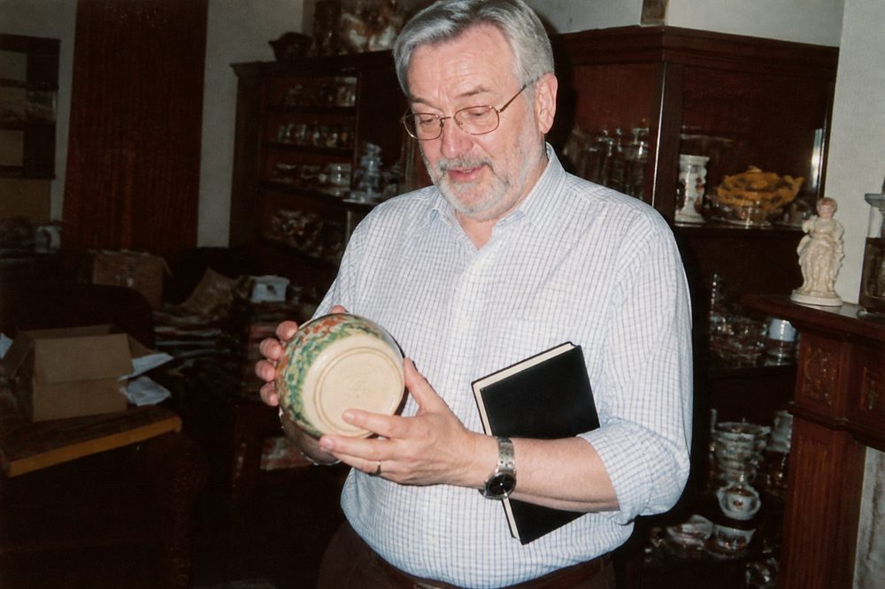 Malcolm Ashby turning a bowl over to read the mark on its base
